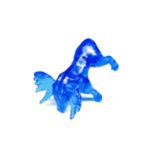 Photo of moose-shaped dice with its nose touching the table